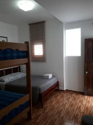 a bedroom with two bunk beds and a window at Cozy and Comfortable Home in MIRAFLORES in Lima