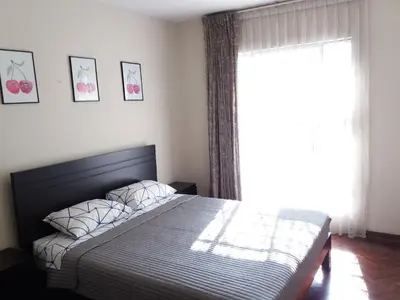 a bedroom with a bed and a large window at Cozy and Comfortable Home in MIRAFLORES in Lima