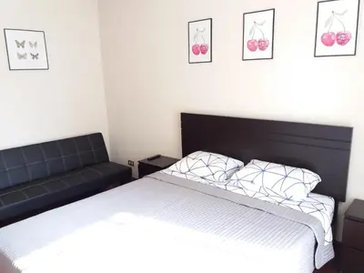 a bedroom with a bed and a couch at Cozy and Comfortable Home in MIRAFLORES in Lima