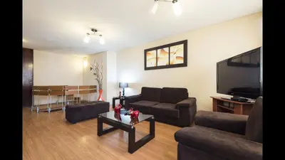 a living room with a couch and a tv at Apartamento PARDO CCA in Lima
