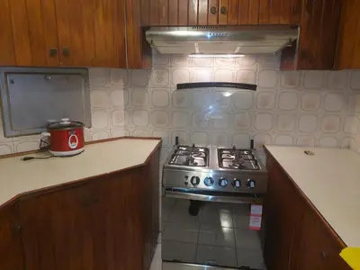 a kitchen with a stove and a counter top at Apartamento PARDO CCA in Lima