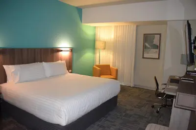 a hotel room with a bed and a desk at Holiday Inn - Lima Airport by IHG in Lima