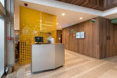 an office with a desk and a yellow wall at Holiday Inn - Lima Airport by IHG in Lima