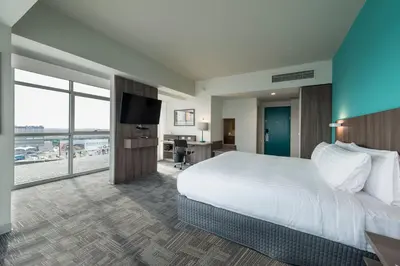 a hotel room with a bed and a flat screen tv at Holiday Inn - Lima Airport by IHG in Lima