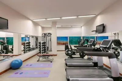 a gym with treadmills and cardio equipment in a room at The Legend Paracas Resort, a Destination by Hyatt Hotel in Paracas