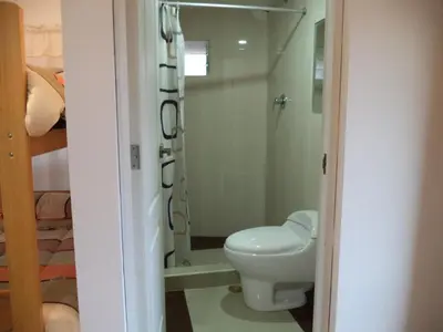 a bathroom with a toilet and a shower at Gringo's Wasi in Cusco