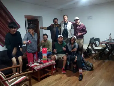 a group of people posing for a picture in a room at Gringo's Wasi in Cusco