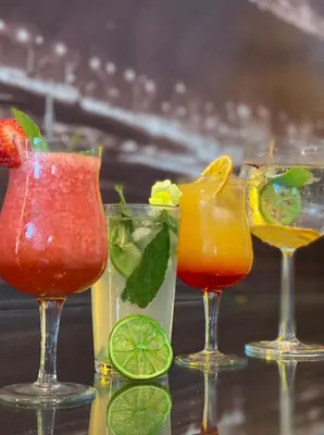 a group of four cocktails sitting on a table at Habitat Hotel in Lima