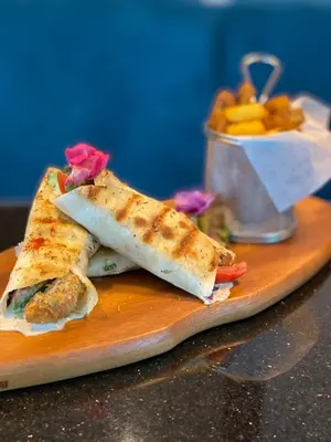 a sandwich cut in half on a cutting board at Habitat Hotel in Lima