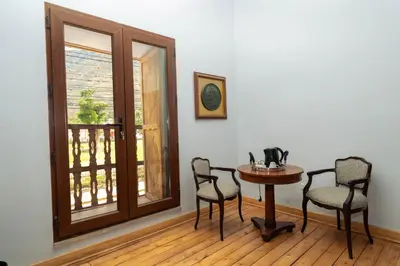 a dining room with a table and chairs and a window at Hotel La Casona De Yucay Valle Sagrado in Urubamba