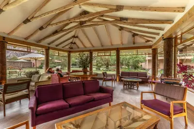 a living room with a couch and tables at Hotel La Casona De Yucay Valle Sagrado in Urubamba