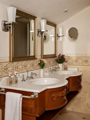 a bathroom with two sinks and a large mirror at Monasterio, A Belmond Hotel, Cusco in Cusco