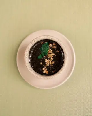 a bowl of food on a plate on a table at Rio Sagrado, A Belmond Hotel, Sacred Valley in Urubamba