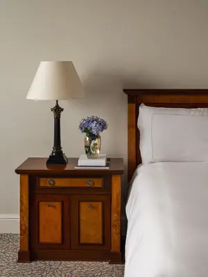a bedroom with a bed and a table with a lamp at Miraflores Park, A Belmond Hotel, Lima in Lima