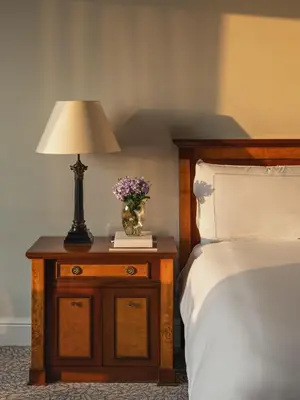 a lamp on a night stand next to a bed at Miraflores Park, A Belmond Hotel, Lima in Lima