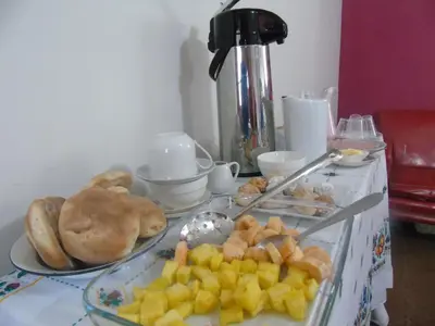 a table topped with plates of food on a table at Pousada Villa Huaripampa in Jauja