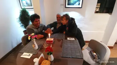 a group of people sitting around a table with a candle at Pousada Villa Huaripampa in Jauja