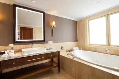 a bathroom with a large tub and a large mirror at Country Club Lima Hotel – The Leading Hotels of the World in Lima