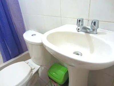 a bathroom with a white sink and a toilet at Sandel in Barranca