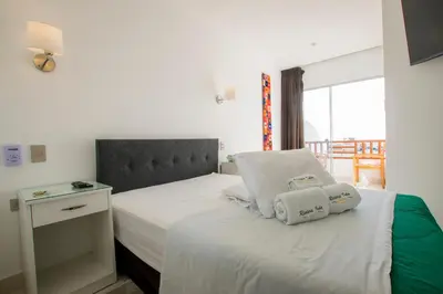 a bed with two pillows on it in a bedroom at Hotel Riviera Inka Paracas in Paracas
