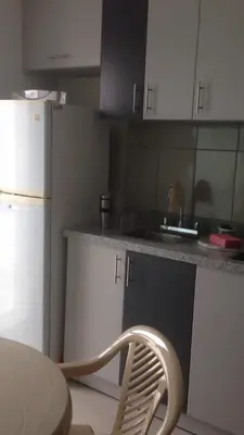 a kitchen with a sink and a white refrigerator at Departamentos Playa San Bartolo in San Bartolo