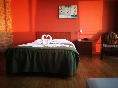a bedroom with red walls and a bed with two white towels at Meflo Playa Grande in Chala