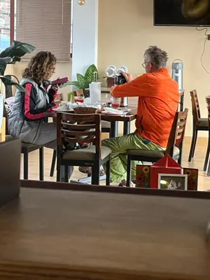 a man and a woman sitting at a table at Prince Hospedaje in Ayacucho