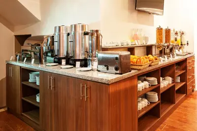 a kitchen with a counter with a coffee maker at Inti Punku Machupicchu Hotel & Suites in Machu Picchu