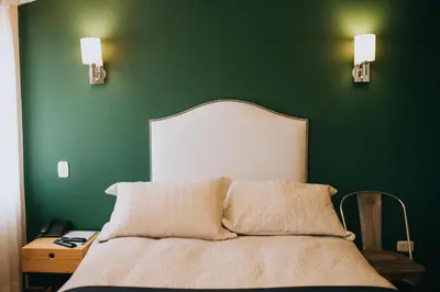 a green bedroom with a bed and a green wall at Anden Inca Hotel in Cusco