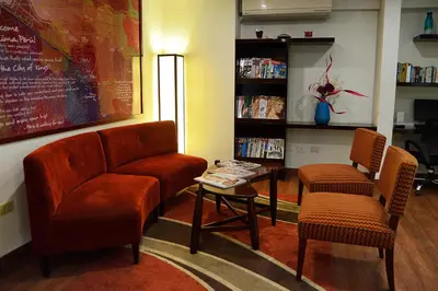 a living room with two chairs and a table at Girasoles Hotel in Lima