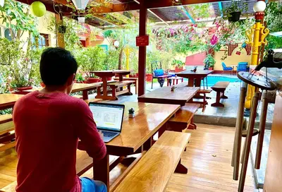 a person sitting at a table with a laptop at Peru Star Apart-Hotel in Lima