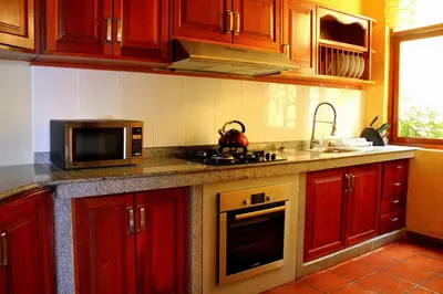 a kitchen with a microwave and a stove top oven at Peru Star Apart-Hotel in Lima