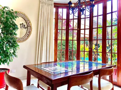 a dining room with a glass table and chairs at Peru Star Apart-Hotel in Lima