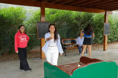 a group of women standing around a table at Casa Andina Standard Chincha in Chincha Alta