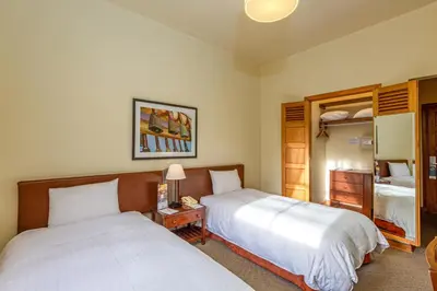 a hotel room with two beds and a mirror at LP Los Portales Hotel Tarma in Tarma