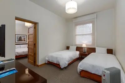 a bedroom with two beds and a mirror at LP Los Portales Hotel Tarma in Tarma