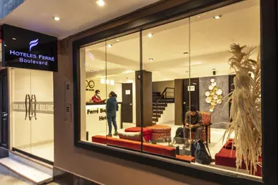 a window of a store with a man standing in a store at Hotel Ferré Boulevard in Machu Picchu