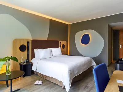a hotel room with a bed and a table at Pullman Lima San Isidro in Lima
