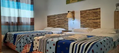two beds sitting next to each other in a room at Hostal Brisa Marina in Paracas