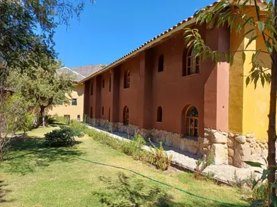 a large building with a yard in front of it at Willka Rumi in Urubamba