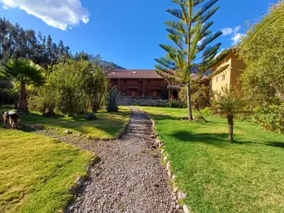 a garden with a path leading to a house at Willka Rumi in Urubamba