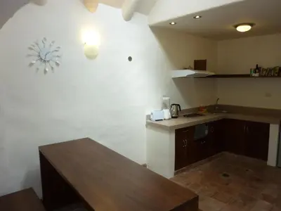 a kitchen with a table and a counter top at Kutty Wasi in Cusco