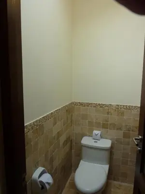 a bathroom with a toilet and a toilet paper dispenser at Kutty Wasi in Cusco