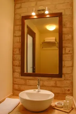 a bathroom with a white sink and a mirror at Kutty Wasi in Cusco