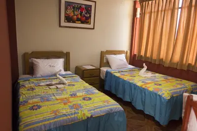 two beds with stuffed animals on them in a room at Hostal Las Fresas Lima Airport in Lima