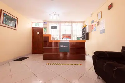 a lobby with a waiting room with a couch at Hostal Las Fresas Lima Airport in Lima