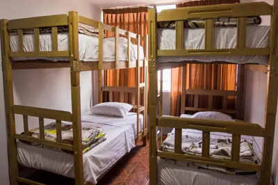 a room with two bunk beds in a hostel at Hostal Las Fresas Lima Airport in Lima