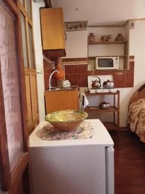a kitchen with a bowl on top of a counter at Casa De Mama Cusco - The Treehouse in Cusco