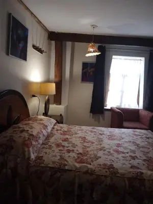 a bedroom with a bed and a window at Casa De Mama Cusco - The Treehouse in Cusco