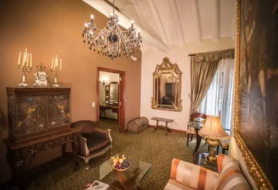 a living room with a chandelier and a couch at Aranwa Cusco Boutique Hotel in Cusco